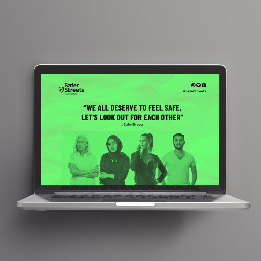 Laptop mockup of the Safer Streets Warrington website homepage, featuring a green banner with diverse figures and the message 'We all deserve to feel safe, let's look out for each other
